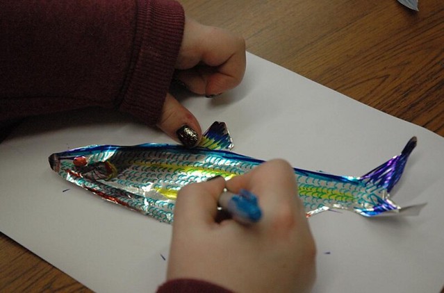 child colouring in a fish picture